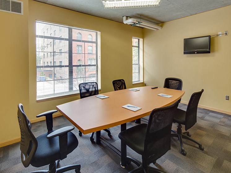 Conference room with oval table and office chairs